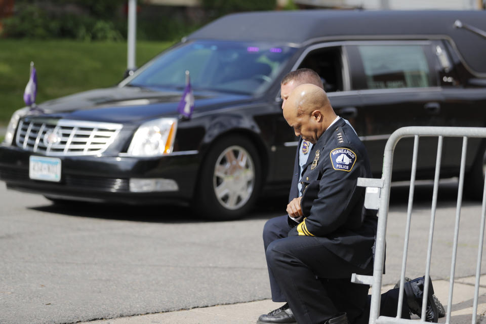 FILE - In this June 4, 2020, file photo, police officers including Minneapolis Police Chief Medaria Arradondo, foreground, take a knee as the body of George Floyd arrives before his memorial services in Minneapolis. George Floyd’s death and the protests it ignited nationwide over racial injustice and police brutality have raised questions about whether Arradondo — or any chief — can fix a department that's now facing a civil rights investigation. (AP Photo/Julio Cortez, File)