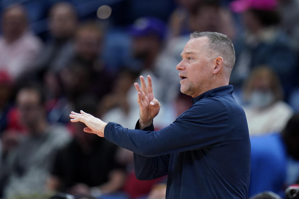 Denver Nuggets head coach Michael Malone calls out from the bench in the first half of an NBA basketball game against the New Orleans Pelicans in New Orleans, Wednesday, Dec. 8, 2021. (AP Photo/Gerald Herbert)