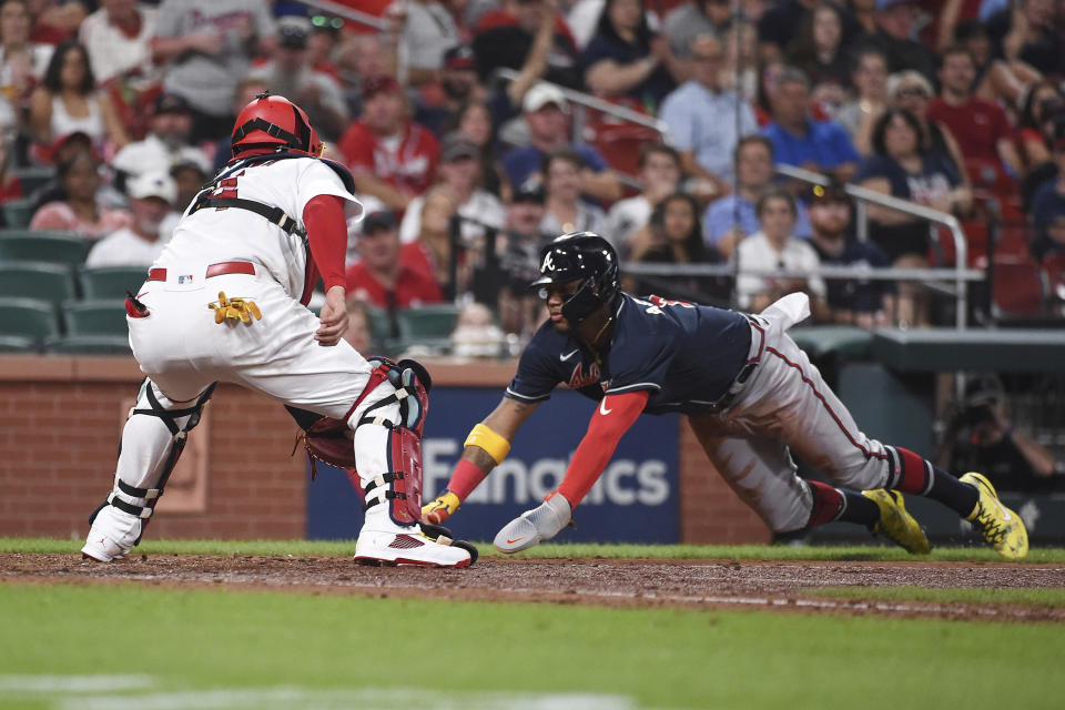 St. Louis Cardinals catcher Yadier Molina (4) tags out Atlanta Braves' Ronald Acuna Jr. (13) at home plate in the eighth inning of a baseball game on Friday, Aug. 26, 2022, in St. Louis. (AP Photo/Joe Puetz)