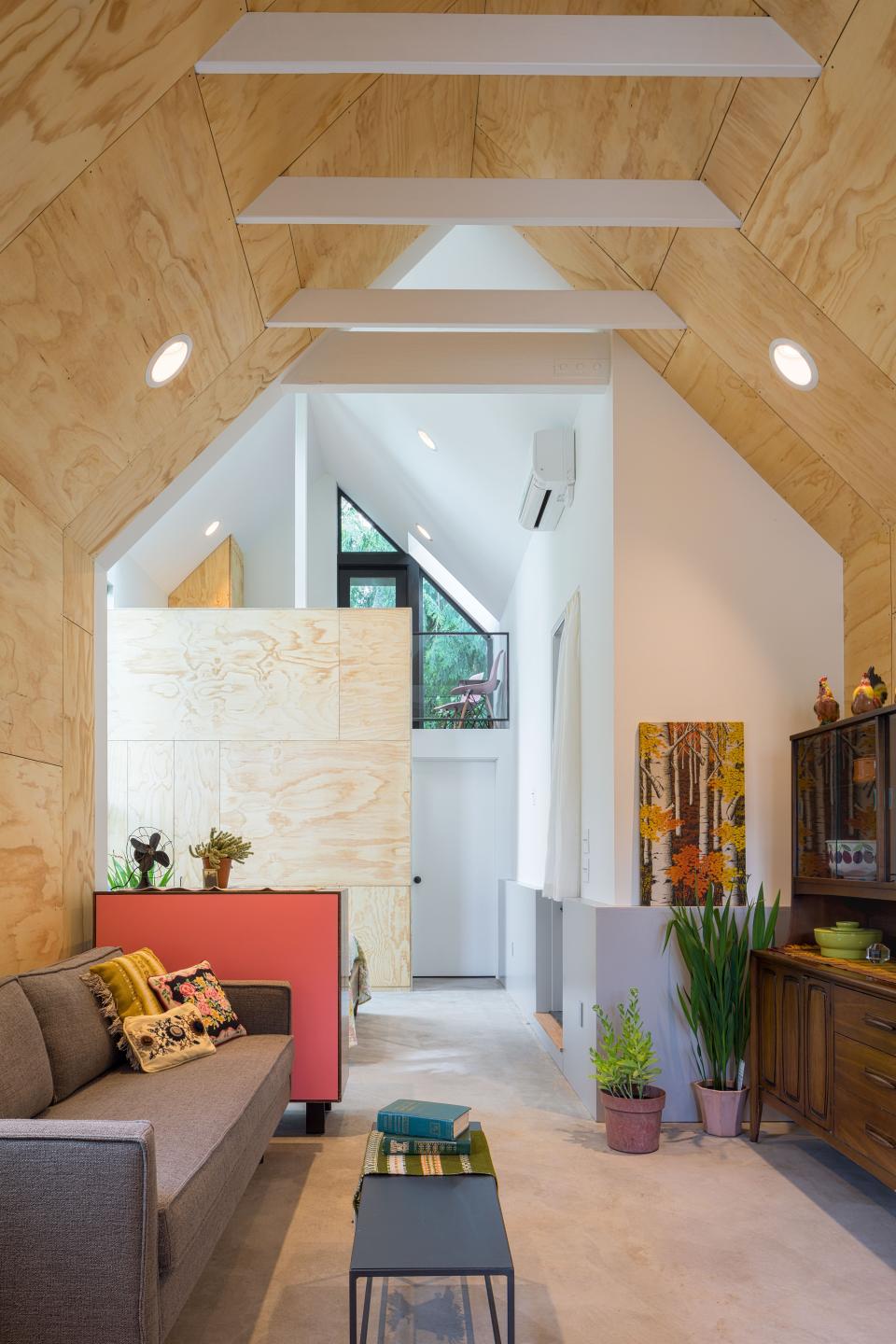 In contrast to the sleek exterior, the inside of the DADU (detached accessory dwelling unit) is voluminous and bright, finished with plywood panels and polished concrete floors. Making the most of 571 square feet, a simple vernacular shape and sight lines from the front door to the rear yard create a relaxed roominess.