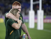 South Africa's Faf de Klerk is embraced by teammate Steven Kitshoff following their Rugby World Cup Pool B game at International Stadium between New Zealand and South Africa in Yokohama, Japan, Saturday, Sept. 21, 2019. New Zealand defeated South Africa 23-13. (AP Photo/Jae Hong)