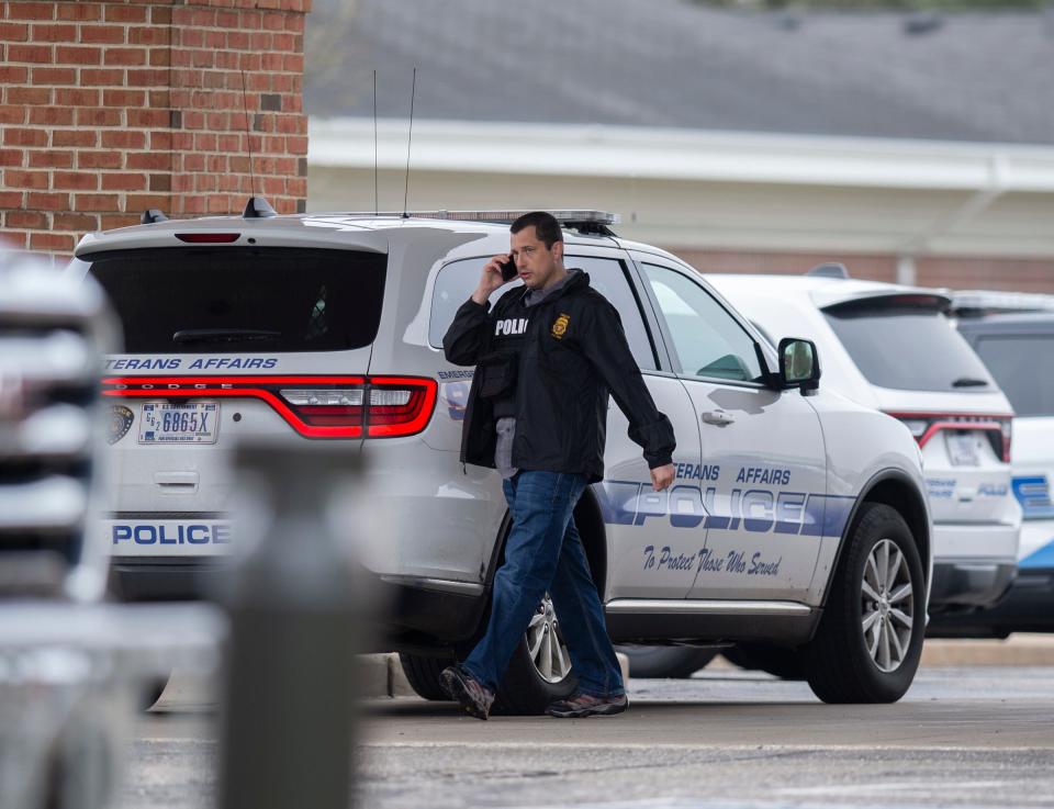 VA officer on the phone leaving the Ravenna VA Out Patient Clinic on Chestnut street.