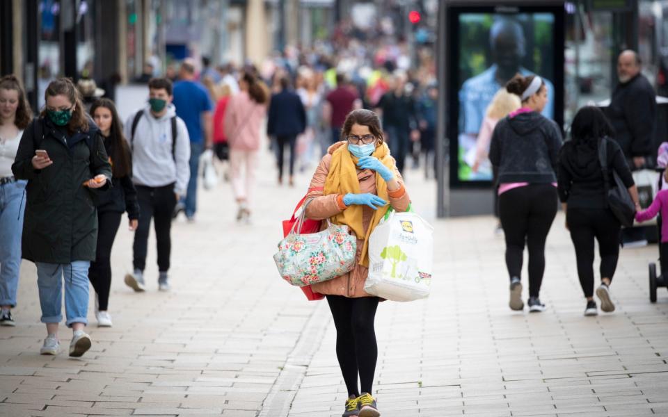 A shopper wears a protective face mask in Edinburgh's Princes Street - PA