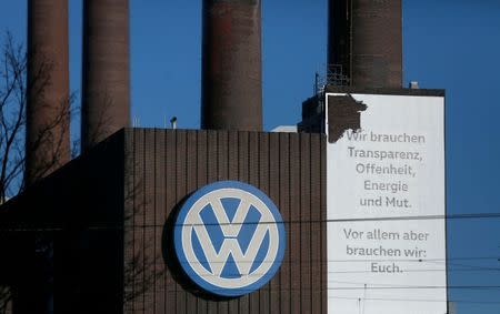 A Volkswagen company logo adorns the VW factory in Wolfsburg, Germany November 20, 2015. Text reads : 'We need transparancy, openess, energy and courage.' REUTERS/Ina Fassbender