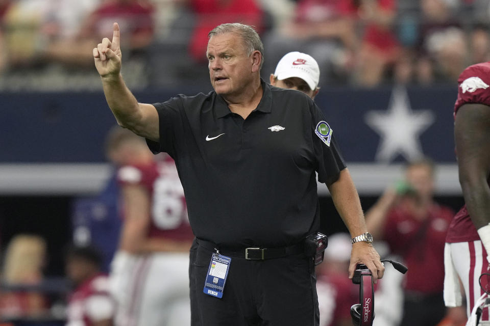 Arkansas head coach Sam Pittman signals to officials during the first half of an NCAA college football game against Texas A&M, Saturday, Sept. 30, 2023, in Arlington, Texas. (AP Photo/LM Otero)