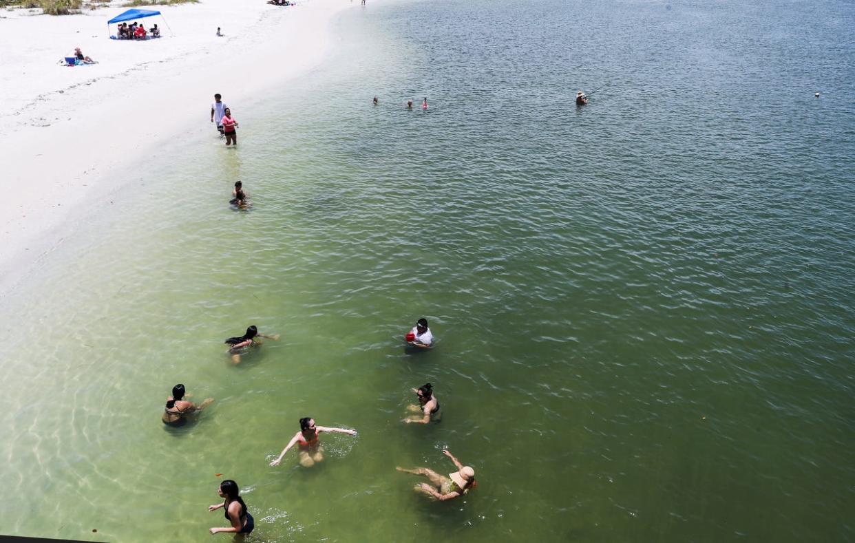 Beachgoers float in Big Carlos Pass on the north end of Lovers Key in this  June, 29, 2020 file photo. The beach access points are closed this Labor Day weekend 2022 "due to an abundance of caution," officials said.