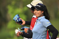 Patty Tavatanakit of Thailand smiles and walks along the green on the 14th hole during the final round of the LPGA Honda Thailand golf tournament in Pattaya, southern Thailand, Sunday, March 13, 2022. (AP Photo/Kittinun Rodsupan)