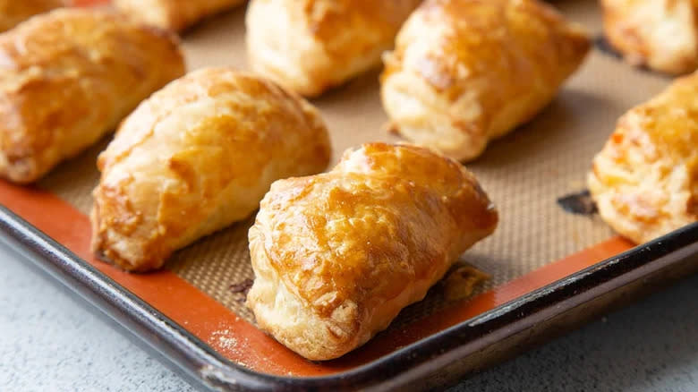 Puff pastry parcels on baking tray