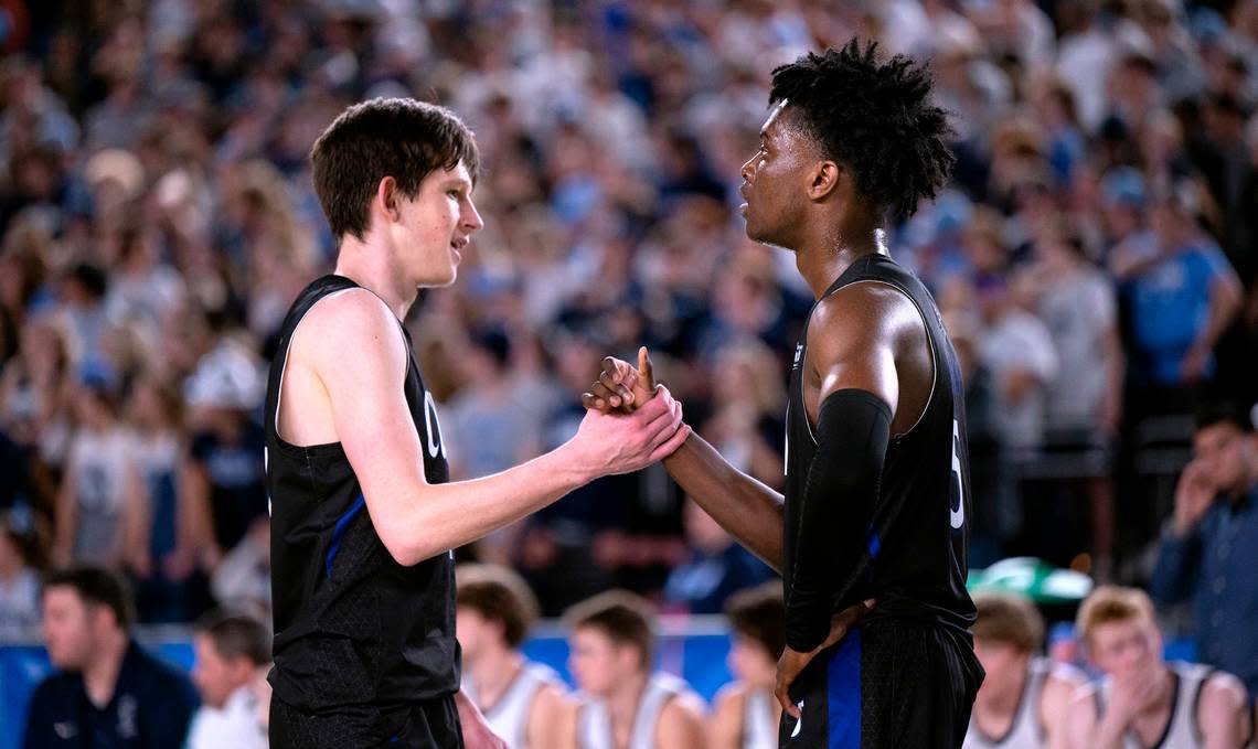 Curtis’ Tyce Paulsen and Zoom Diallo congratulate one another late in the 4A boys state title game against the Olympia Bears at the WIAA state basketball tournament in the Tacoma Dome in Tacoma, Washington, on Saturday, March 4, 2023. Curtis won the game, 49-43.