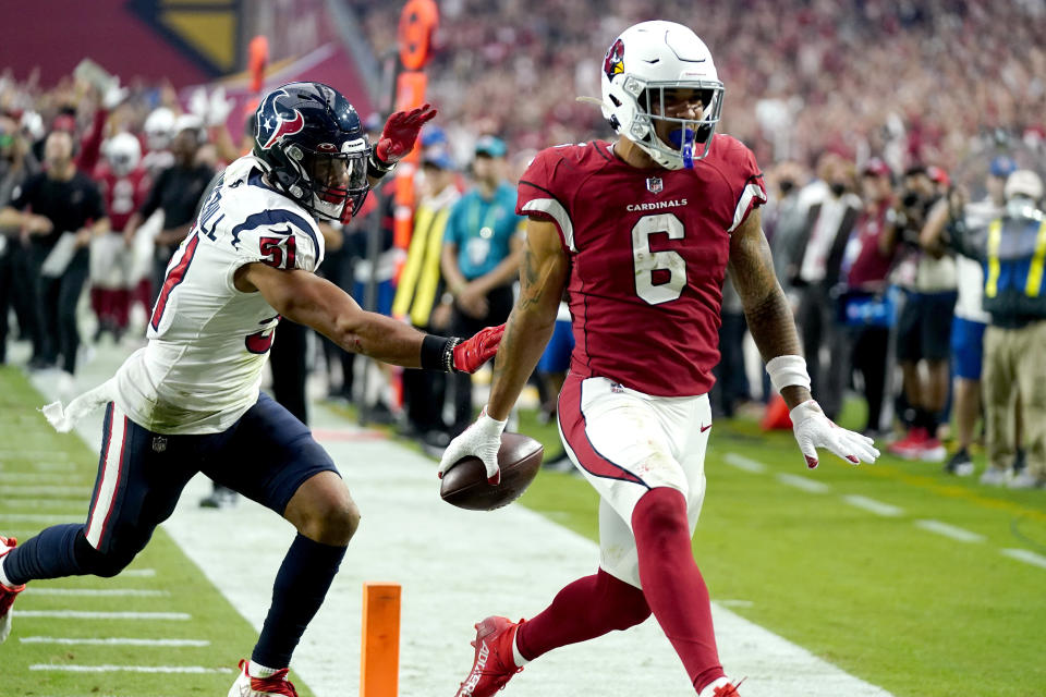 Arizona Cardinals running back James Conner (6) scores a touchdown as Houston Texans outside linebacker Kamu Grugier-Hill (51) defends during the second half of an NFL football game, Sunday, Oct. 24, 2021, in Glendale, Ariz. (AP Photo/Ross D. Franklin)