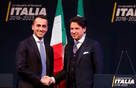 FILE PHOTO: 5-Star Movement leader Di Maio shakes hands with Giuseppe Conte in Rome ahead of Italy's election, March 1, 2018. REUTERS/Remo Casilli/File Photo