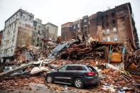 A car sits amongst the rubble after an explosion destroyed four buildings in New York, March 27, 2015. REUTERS/Nancy Borowick/Pool