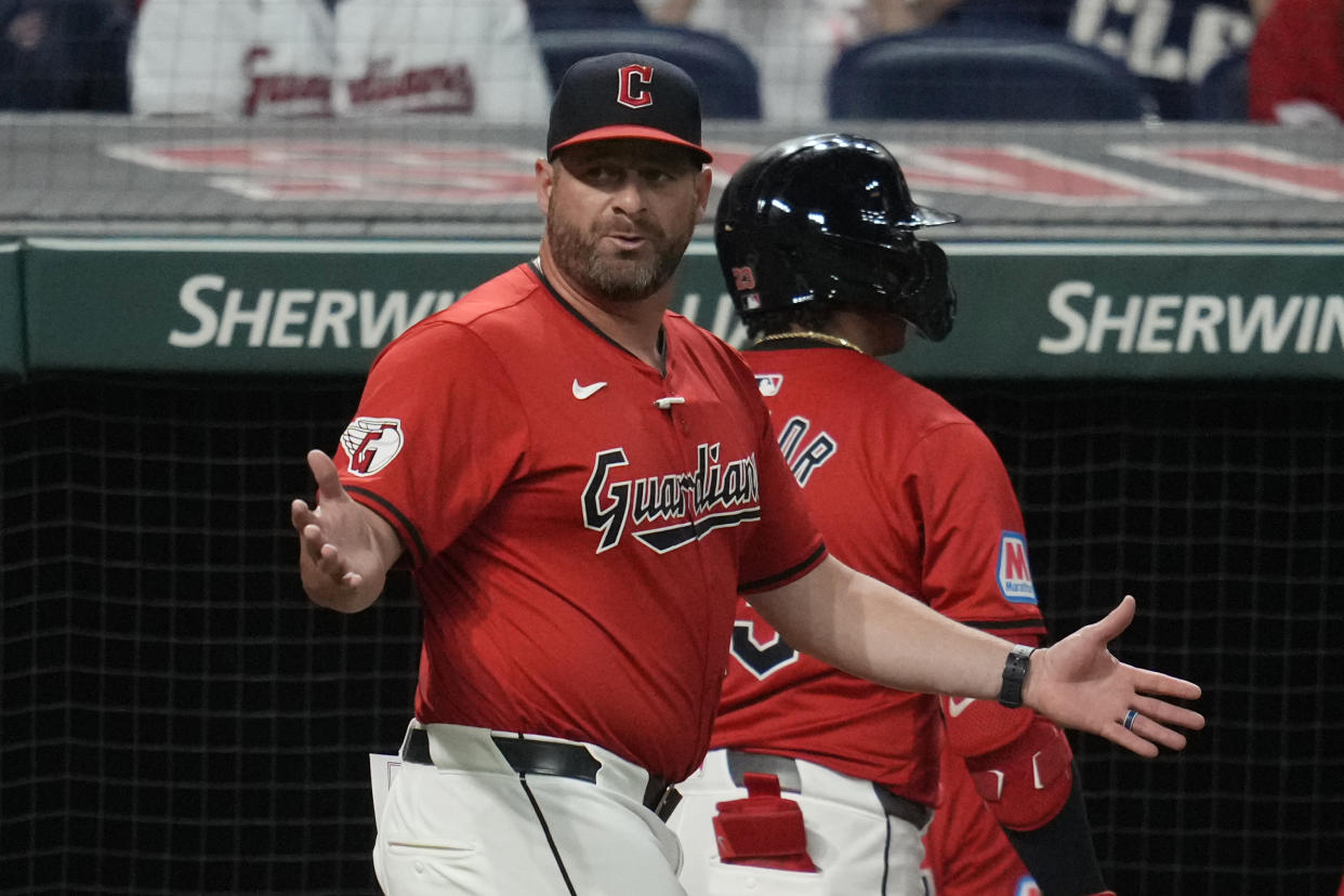 Cleveland Guardians manager Stephen Vogt, left, gestures to home plate umpire Carlos Torres after Bo Naylor, right, was called out on strikes in the fifth inning of a baseball game against the Minnesota Twins, Monday, Sept. 16, 2024, in Cleveland. (AP Photo/Sue Ogrocki)