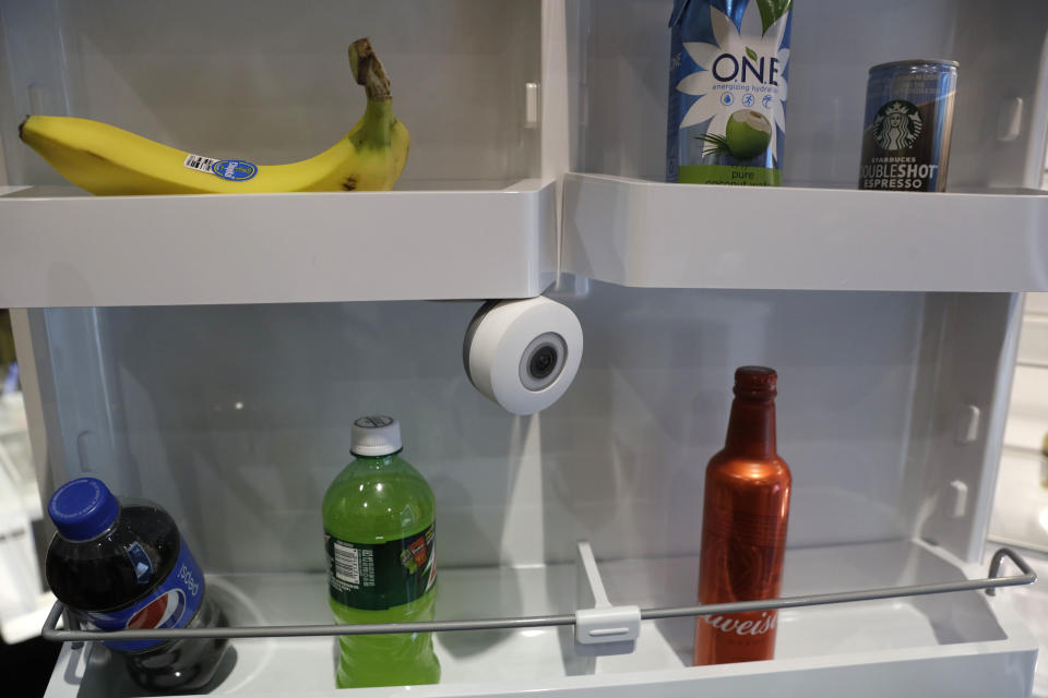 The FridgeCam is displayed at the Smarter booth during CES Unveiled, Tuesday, Jan. 3, 2017, in Las Vegas. The camera takes a picture every time you use the refrigerator and has recognition software that can alert you when something in the refrigerator is about to pass its expiration. (AP Photo/John Locher)