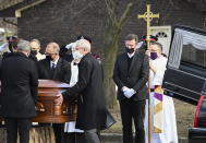 Hockey hall-of-fame legend Wayne Gretzky, second right, cries as he watches the casket of his father, Walter Gretzky, be carried from the church during a funeral service in Brantford, Ontario, on Saturday, March 6, 2021. Walter Gretzky also know as Canada's hockey dad was 82 years-old. (Nathan Denette/The Canadian Press via AP)
