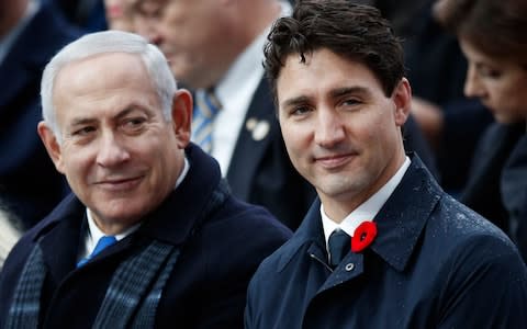 Israeli Prime Minister Benjamin Netanyahu (L) and Canadian Prime Minister Justin Trudeau attend a ceremony at the Arc de Triomphe in Paris  - Credit: AFP