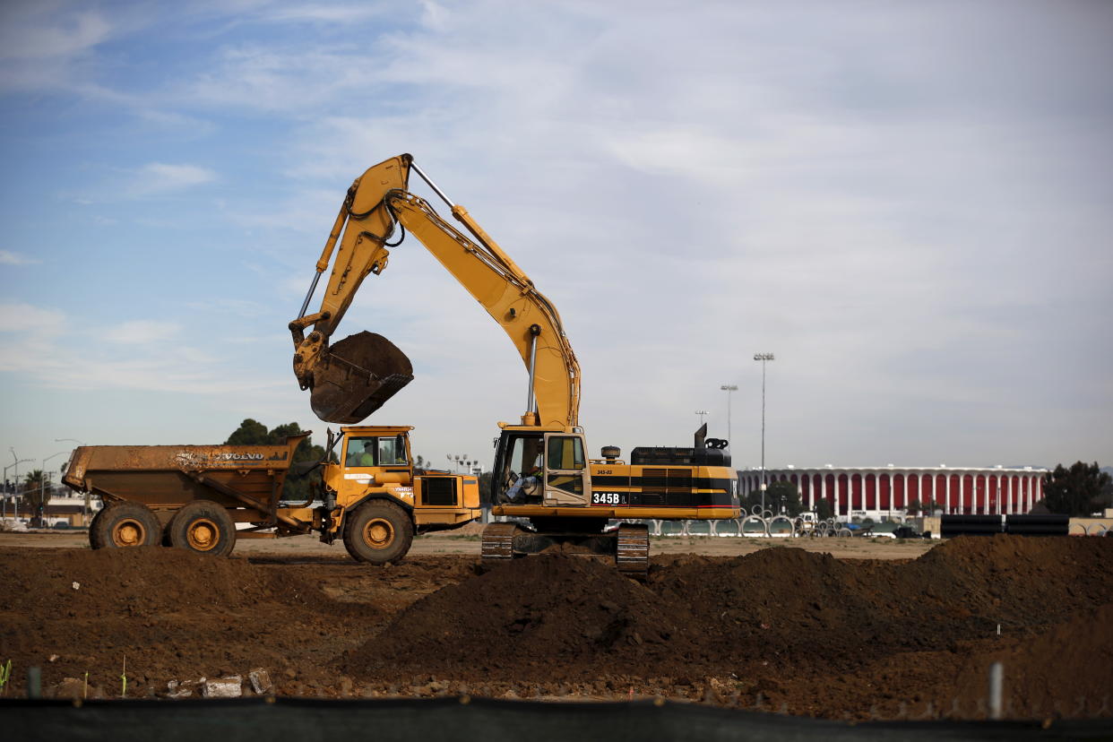 An excavator works on the site of the new $1.85 billion stadium where the Los Angeles Rams will play in Inglewood, Los Angeles, California, United States, January 13, 2016. The St. Louis Rams are moving to Los Angeles after National Football League owners voted to approve their relocation efforts on Tuesday and gave the San Diego Chargers the option to join them. The Rams' proposal to relocate to a planned $1.85 billion facility in Inglewood, roughly 10 miles from downtown Los Angeles, was approved by owners by a vote of 30-2 according to a report on the NFL's website. REUTERS/Lucy Nicholson      TPX IMAGES OF THE DAY     