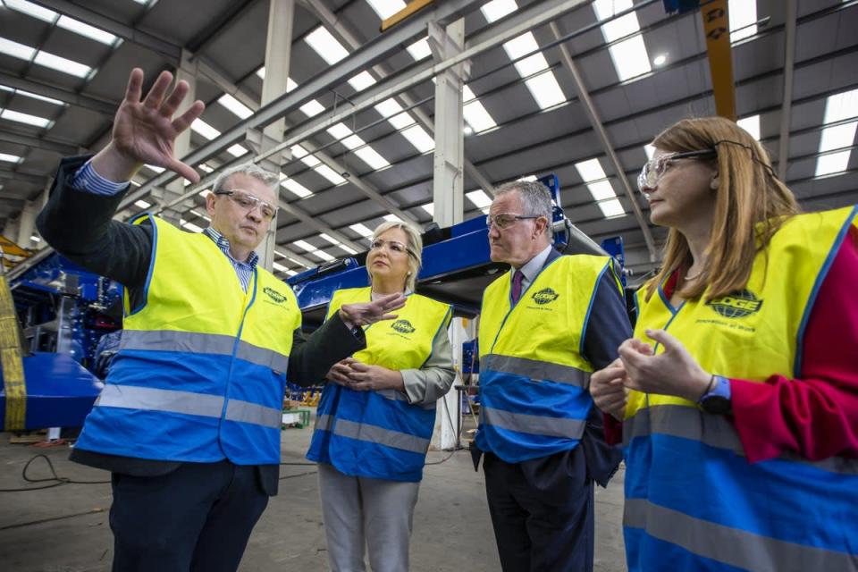 Darragh Cullen (left) shows Sinn Fein vice president Michelle O’Neill (second left) around the factory floor of his plant (Liam McBurney/PA) (PA Wire)