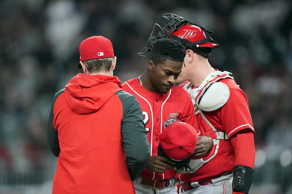 Cincinnati Reds starting pitcher Reiver Sanmartin (52) leaves the field after being relieved in the third inning of a baseball game against the Atlanta Braves Friday, April 8, 2022, in Atlanta. (AP Photo/John Bazemore)