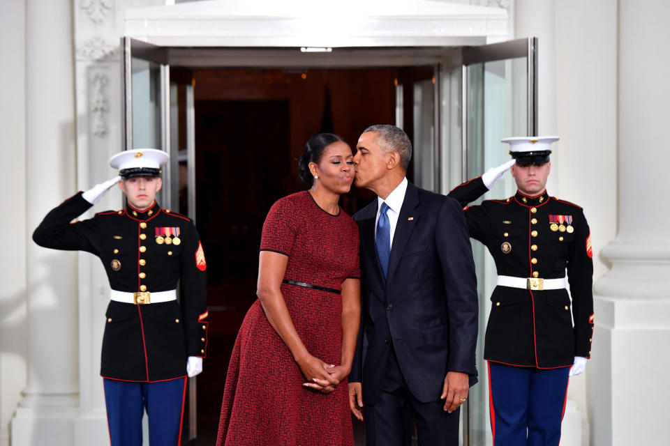 <p>Obama gives Michelle a tender kiss as they wait for Donald Trump at the White House. <em>[Photo: Getty]</em> </p>