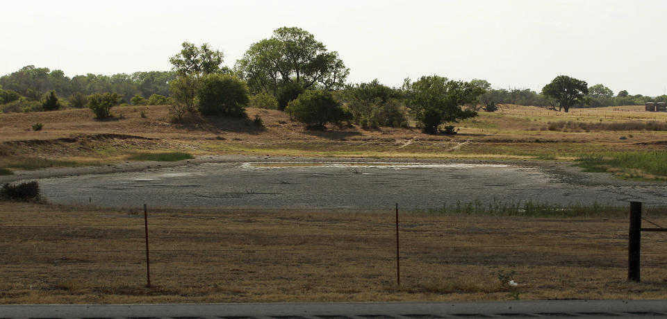 In this Wednesday, July 18, 2012 photo, a nearly empty farm pond is pictured near Watonga, Okla. The nation's widest drought in decades is spreading, with more than half of the continental United States now in some stage of drought and most of the rest enduring abnormally dry conditions. (AP Photo/Sue Ogrocki)