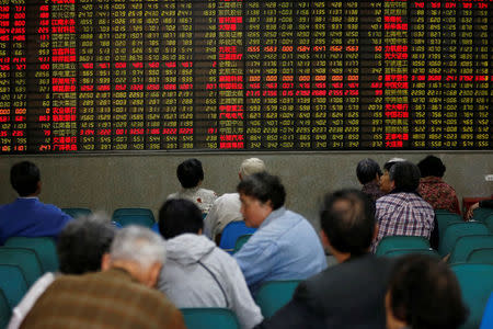 Investors look at an electronic board showing stock information at a brokerage house in Shanghai, China, April 21, 2016. REUTERS/Aly Song/File photo