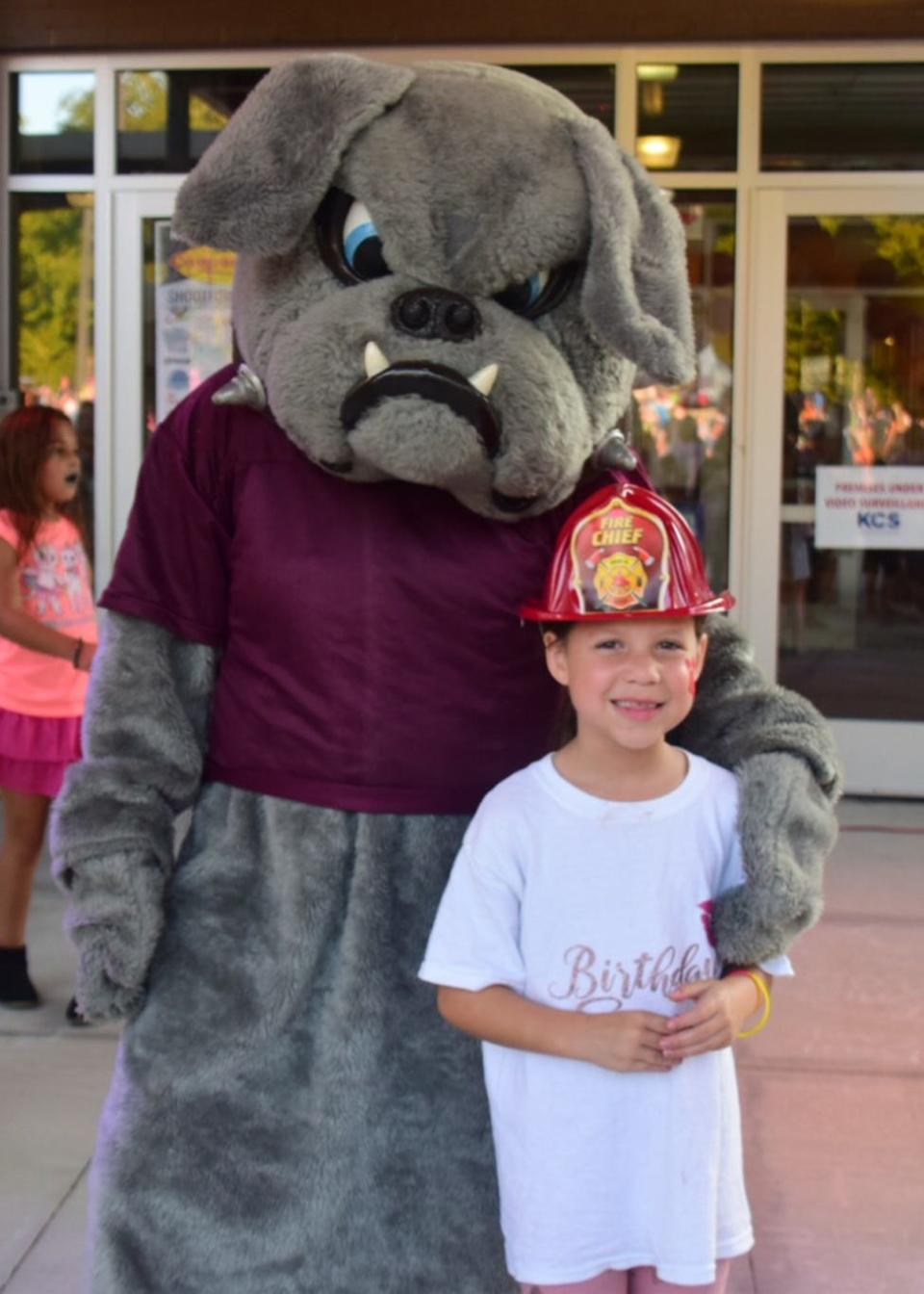 Cheyenne Chamberlain, 8, takes a paws with Bones the Bulldog at the 2019 Fall Carnival at Ball Camp Elementary School.