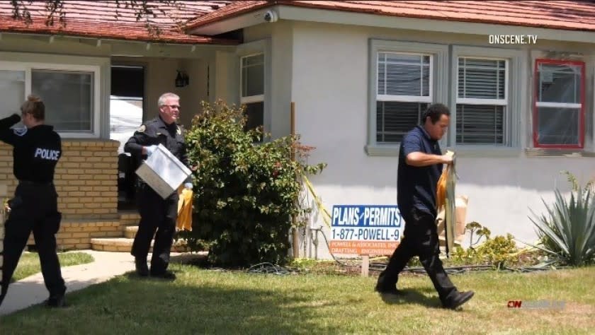 Investigators remove evidence from a home in Downey after arresting a man Thursday on suspicion of animal cruelty.
