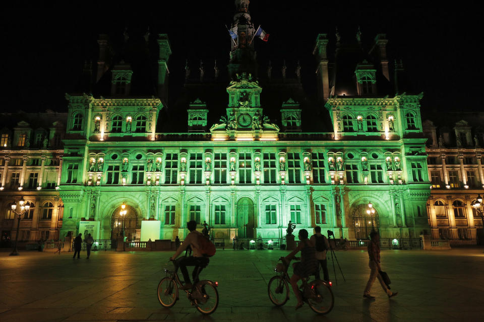 Green lights are projected onto the facade of the Hotel de Ville in Paris, France, after Trump announced his decision that the United States will withdraw from the Paris Climate Agreement. (Photo: Philippe Wojazer / Reuters)