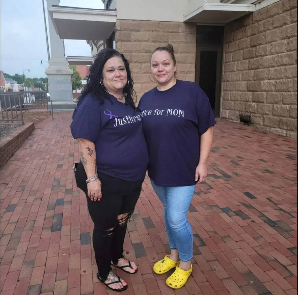 Angie Little and Mandy Chardoudi wear matching shirts outside the Robeson County Courthouse.
