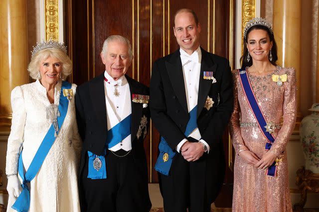 <p>Chris Jackson/Getty</p> Queen Camilla, King Charles III, Prince William, Prince of Wales and Catherine, Princess of Wales pose for a photograph ahead of The Diplomatic Reception in the 1844 Room at Buckingham Palace on December 05, 2023 in London, England.