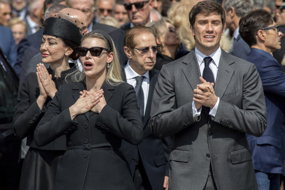 Family members of former Italian Premier Silvio Berlusconi, from left, daughters Eleonora and Barbara, and son Luigi, acknowledge the crowd at the end of Berlusconi's state funeral outside the Milan's Gothic Cathedral in northern Italy, Wednesday, June 14, 2023. Berlusconi died at the age of 86 on Monday in a Milan hospital where he was being treated for chronic leukemia. (Claudio Furlan/LaPresse via AP)