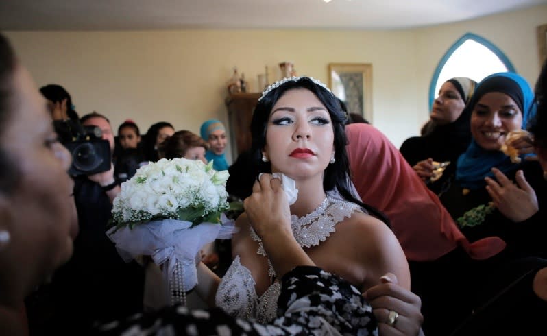Bride Maral Malka, 23, celebrates with friends and family before her wedding to groom Mahmoud Mansour, 26, in Jaffa, south of Tel Aviv August 17, 2014. Israeli police on Sunday blocked more than 200 far-right Israeli protesters from rushing guests at the wedding of a Jewish woman and Muslim man as they shouted "death to the Arabs" in a sign of tensions stoked by the Gaza war. Picture taken August 17, 2014. To match MIDEAST-ISRAEL/WEDDING REUTERS/Ammar Awad