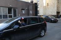 Embassy staff leave the Czech Republic Embassy by a car in Moscow, Russia, Monday, April 19, 2021. Russia has ordered 20 Czech diplomats to leave the country within a day in response to Prague's expulsion of 18 Russian diplomats. The Czech government has alleged the Russian Embassy staffers were spies for a military intelligence agency that was involved in a fatal ammunition depot explosion in 2014. (AP Photo/Pavel Golovkin)