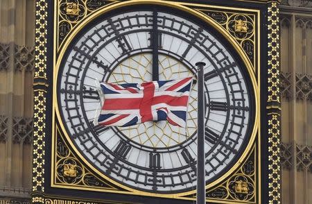 A British Union flag flutters in front of one of the clock faces of the 'Big Ben' clocktower of The Houses of Parliament in central London, Britain, February 22, 2016. REUTERS/Toby Melville/File Photo