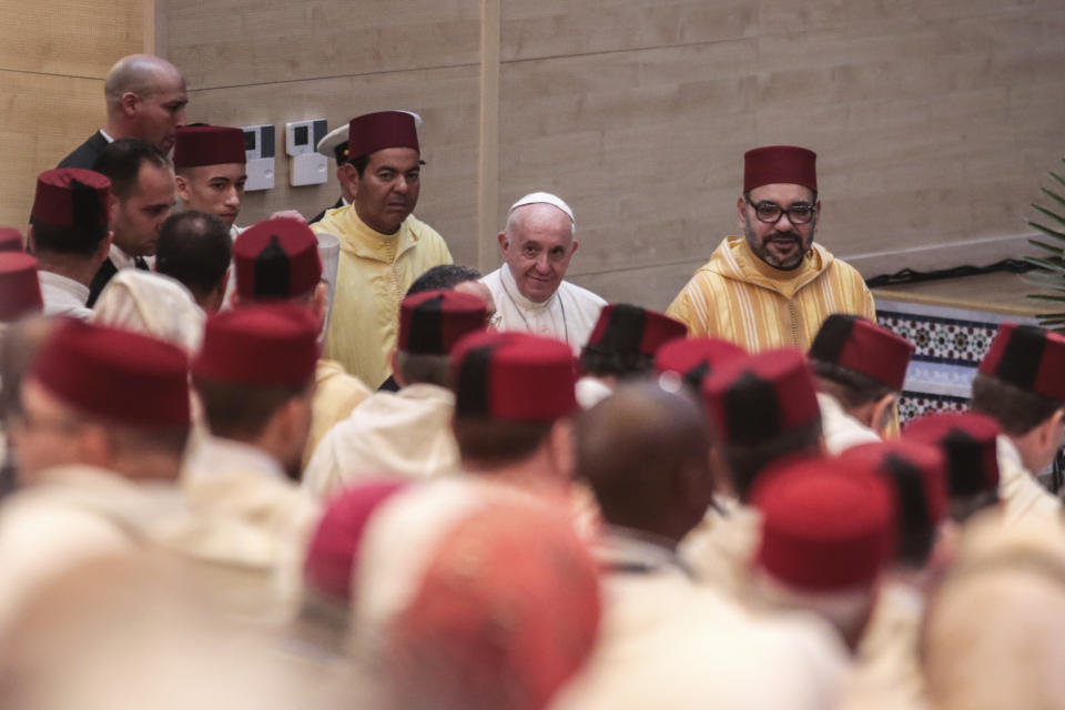 Pope Francis arrives with King Mohamed VI, at the Mohammed VI Institute, a school of learning for imams, in Rabat, Morocco, Saturday, March 30, 2019. Francis's weekend trip to Morocco aims to highlight the North African nation's tradition of Christian-Muslim ties while also letting him show solidarity with migrants at Europe's door and tend to a tiny Catholic flock on the peripheries. (AP Photo/Mosa'ab Elshamy)