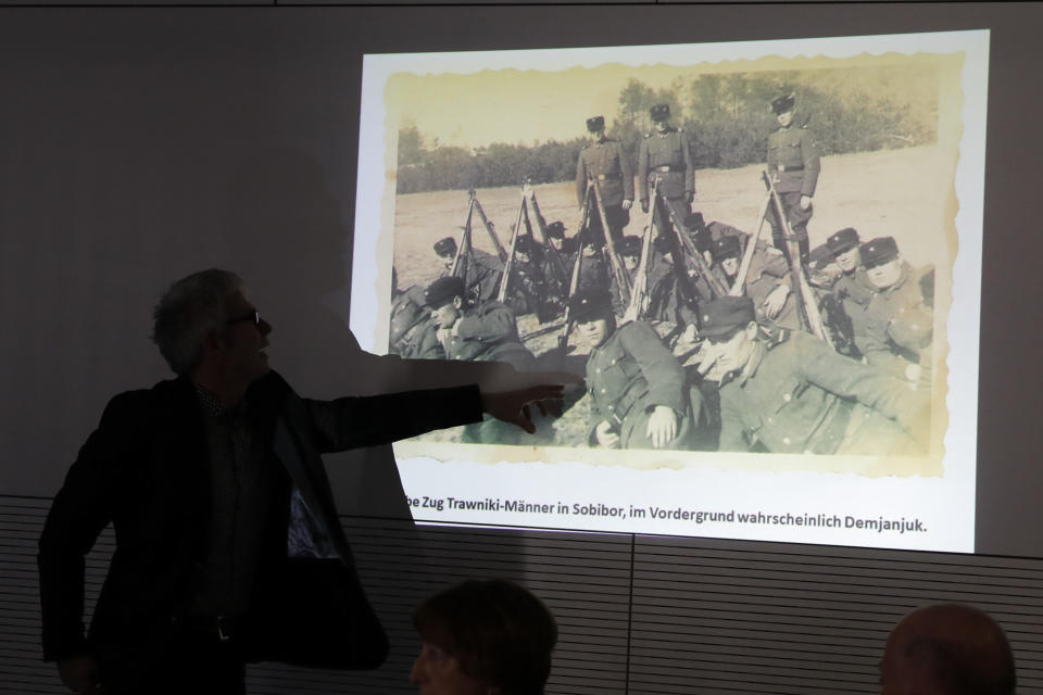 Historian Martin Cueppers points at a man, presumably former security guard John Demjanjuk, at the Nazi death camp Sobibor during a news conference of newly discovered photos from the Sobibor camp in Berlin, Germany, Tuesday, Jan. 28, 2020. (AP Photo/Markus Schreiber)