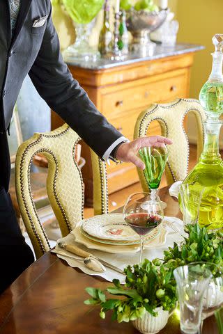 <p>Adam Albright</p> Designer Barry Dixon sets the table for a holiday gathering at his Virginia home.