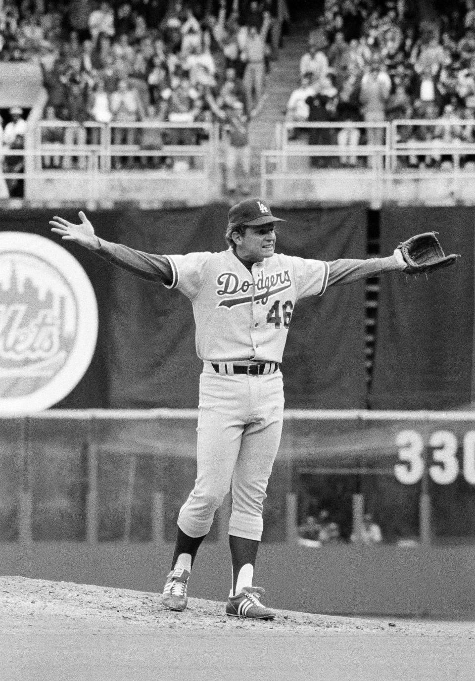 Los Angeles Dodgers pitcher Burt Hooton throws up his hands as if to say, "Now what?" after he walked in the third Phillies run during the third National League playoff game in Philadelphia, Oct. 7, 1977. Dodgers manager Tom Lasorda took him out of the game.