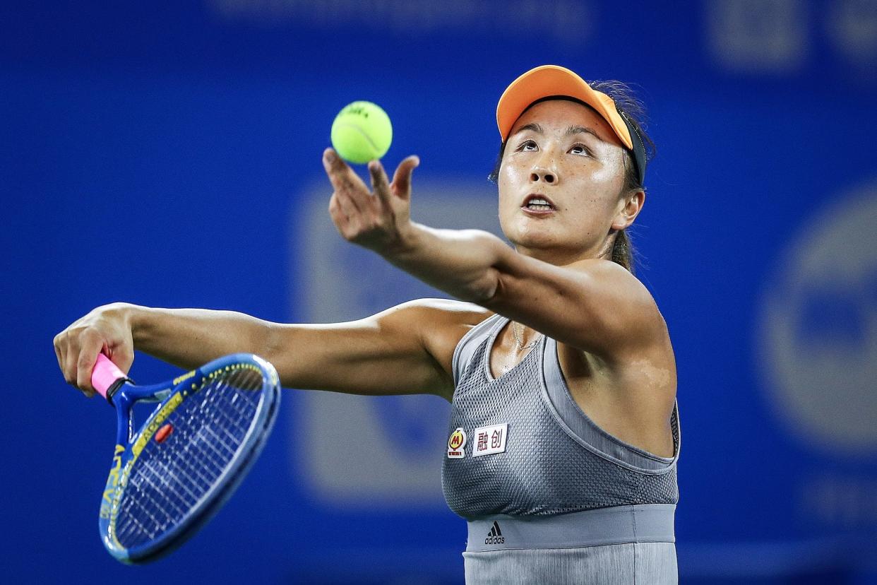 Shuai Peng of China serves during the match against Garbine Muguruza of Spain on Day 2 of 2019 Dongfeng Motor Wuhan Open