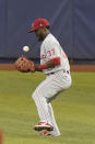 Philadelphia Phillies center fielder Odubel Herrera bobbles a ball hit by Miami Marlins' Jon Berti during the sixth inning of a baseball game, Monday, May 24, 2021, in Miami. (AP Photo/Wilfredo Lee)