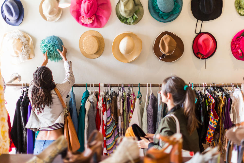 two young women shopping in a thrift store