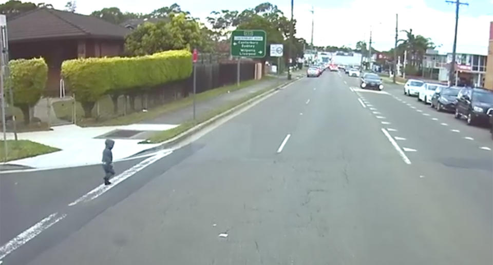 The boy can be seen nearly tripping over as he makes his way onto the road. Source: Facebook