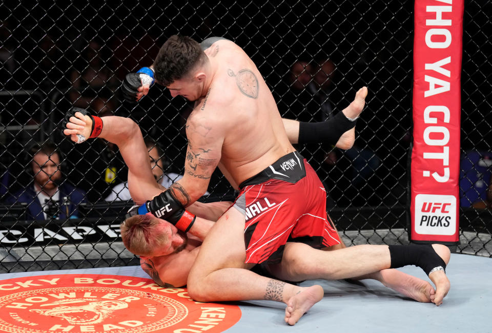 LONDON, ENGLAND - MARCH 19:  (R-L) Tom Aspinall of England punches Alexander Volkov of Russia in a heavyweight fight during the UFC Fight Night event at O2 Arena on March 19, 2022 in London, England. (Photo by Chris Unger/Zuffa LLC)