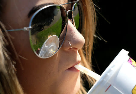 A woman drinks a McDonalds refreshment with a straw in Loughborough, Britain April 19, 2018. REUTERS/Darren Staples