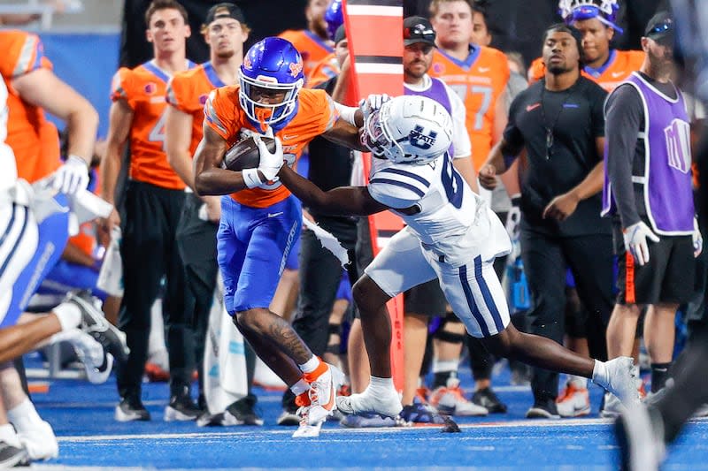 Boise State wide receiver Cameron Bates (80) battles for yards against Utah State safety Ike Larsen (6) after a reception in the second half of an NCAA college football game, Saturday, Oct. 5, 2024, in Boise, Idaho. Boise State won 62-30. (AP Photo/Steve Conner) | Steve Conner