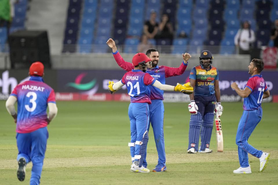 Afghanistan's Mohammad Nabi, center, celebrates with teammates after dismissal of Sri Lanka's Bhanuka Rajapaksa during the T20 cricket match of Asia Cup between Afghanistan and Sri Lanka, in Dubai, United Arab Emirates, Saturday, Aug. 27, 2022. (AP Photo/Anjum Naveed)