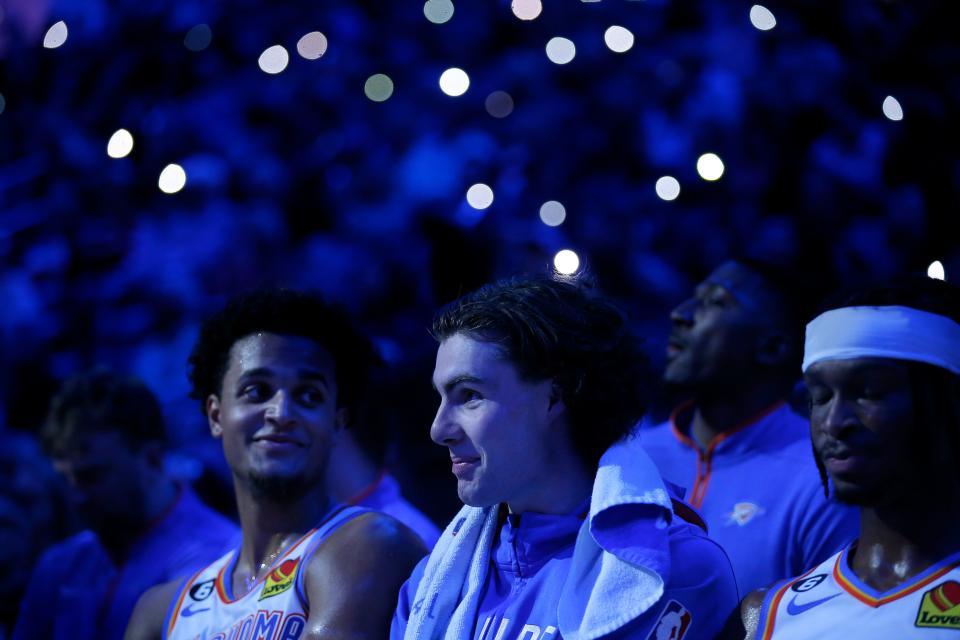 Oklahoma City's Jeremiah Robinson-Earl (50), Josh Giddey (3) and Shai Gilgeous-Alexander (2) sit on the bench during a time out during the NBA basketball game between the Oklahoma City Thunder and the New York Knicks at the Paycom Center in Oklahoma City, Monday, Nov., 21, 2022. 