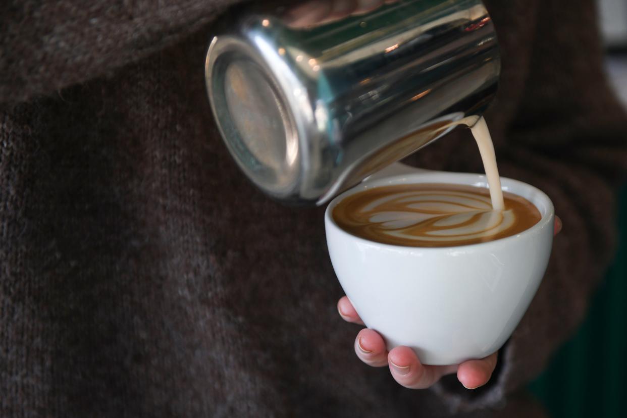 Bentley Hendrix does latte art at Trellis Coffee Bar off Walton Way on Wednesday, Nov. 1, 2023.