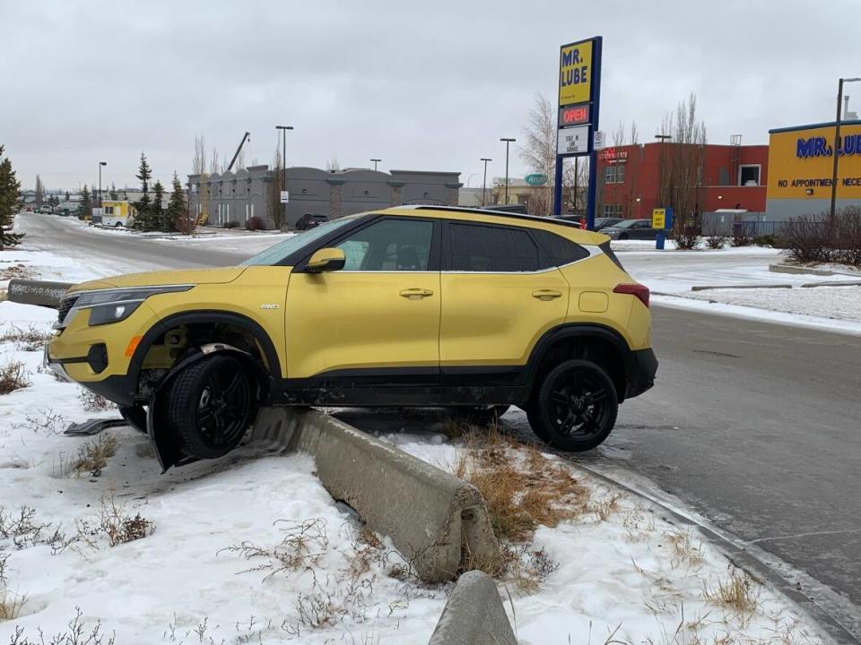 This small SUV got hung up on a concrete barrier along Parsons Road as freezing rain made roads slick in Edmonton Wednesday. (Nathan Gross/CBC - image credit)